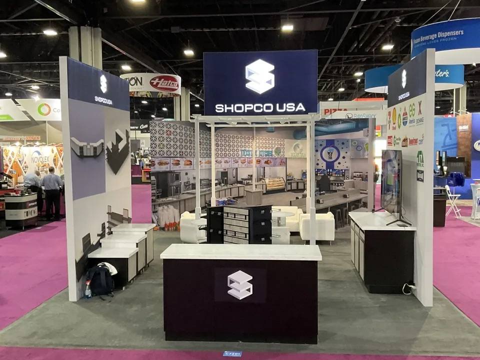 Open island exhibit with overhead signage and illuminated displays
