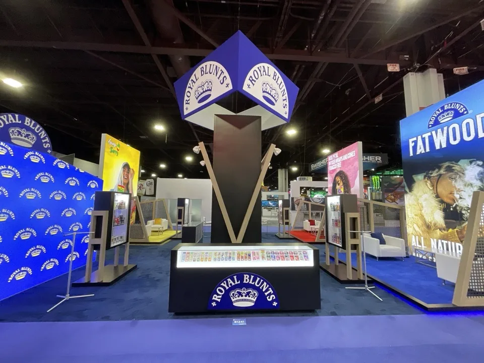 Royal Blunts exhibit with a central illuminated tower and colorful product displays